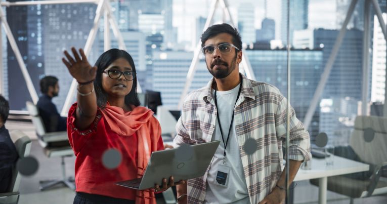 Man and woman in conversation with laptop